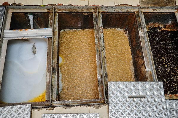 foul odors, slow draining sinks, and gurgling noises are common signs that your grease trap needs maintenance